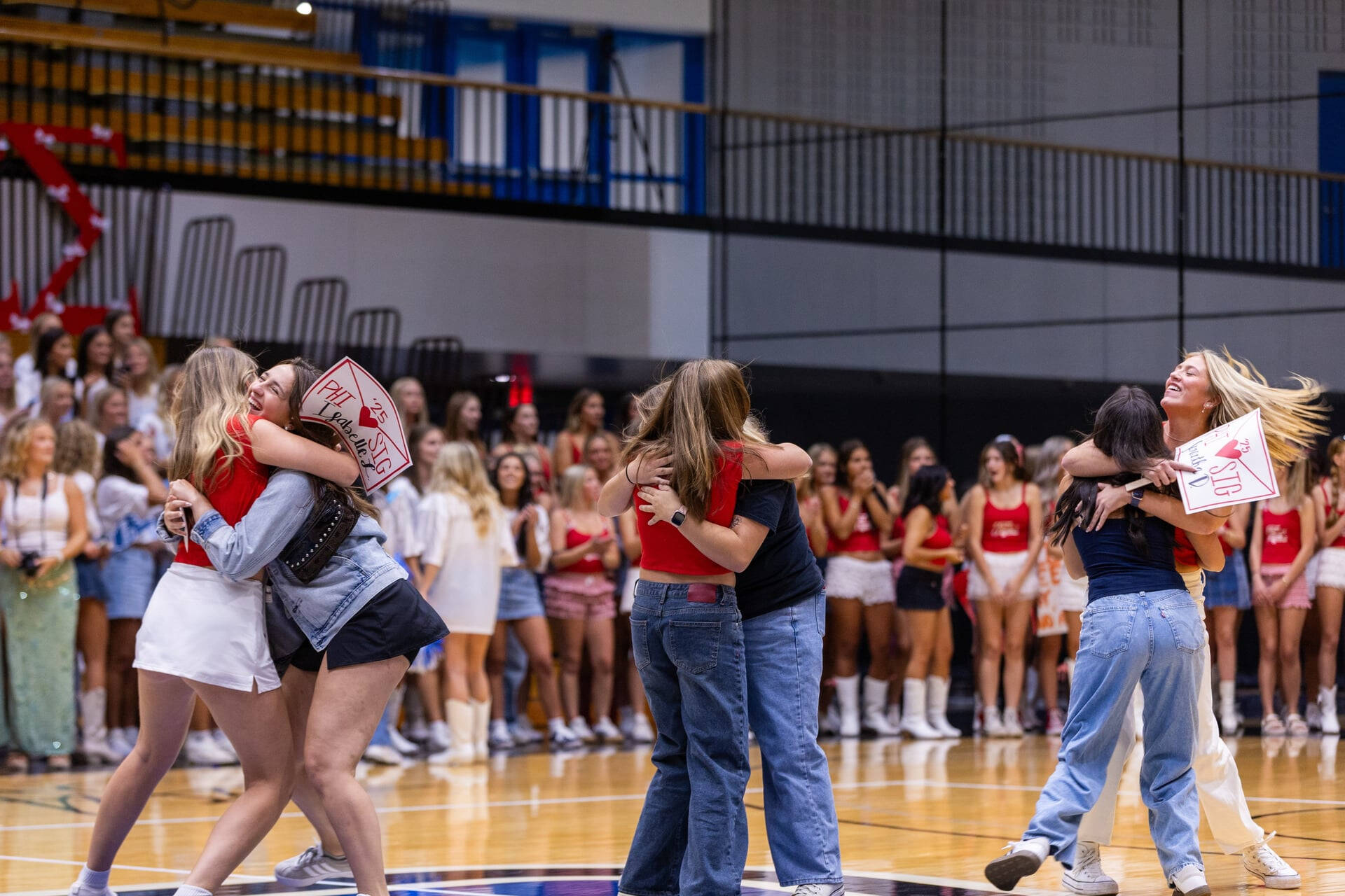 Panhellenic Members hug with excitement at Bid Day